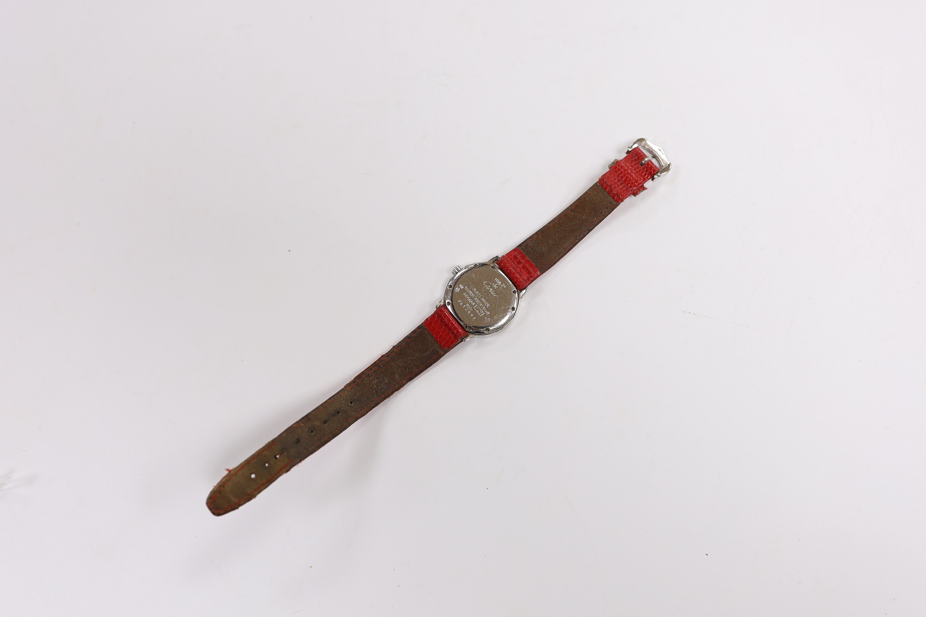 A lady's silver Must de Cartier quartz wrist watch, ref.1806, on a red leather strap, no box or papers, case diameter 27mm.